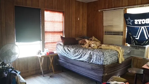a bedroom with a bed and a window