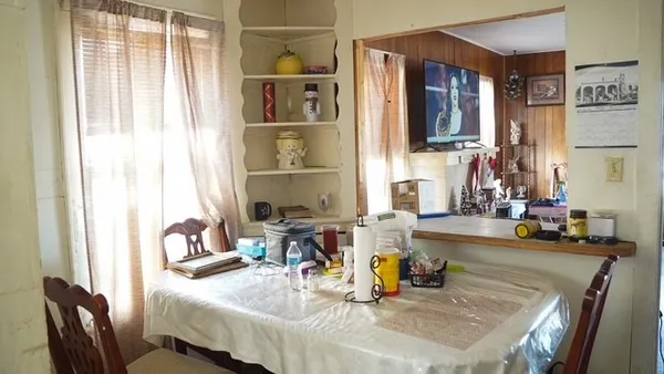 a dining room with furniture and window