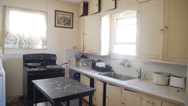 307 North Maria Street Hebbronville, TX 78361 - Photo 6 of 13 a kitchen with a sink a window and cabinets