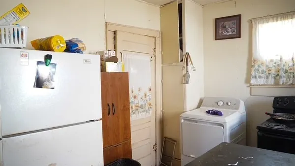 a white refrigerator freezer sitting next to a window