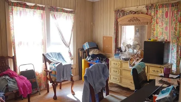 a view of a livingroom with furniture and a window