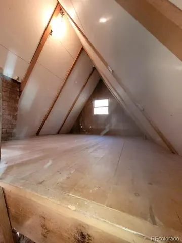 a view of an empty room and wooden floor