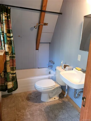 a white toilet sitting next to a bathroom sink