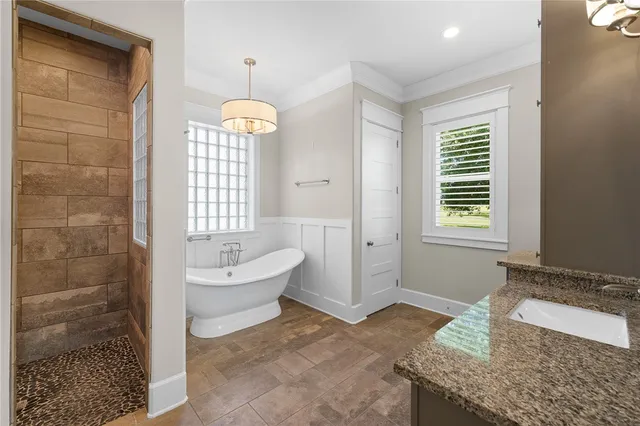 a bathroom with a granite countertop sink a toilet and shower