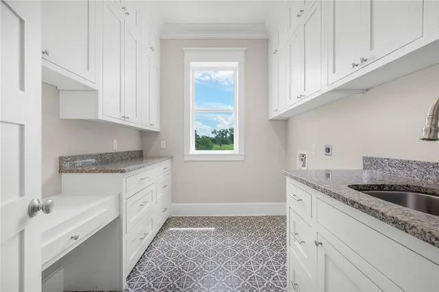 a kitchen with granite countertop white cabinets and white appliances