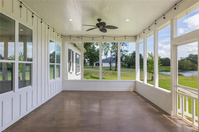 a view of an empty room with a floor to ceiling window and an outdoor view