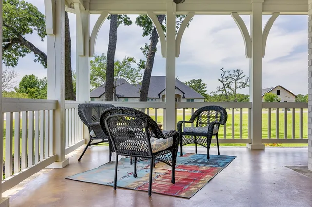 a view of a chairs and table in the balcony