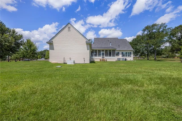 a view of a house with a yard and sitting area