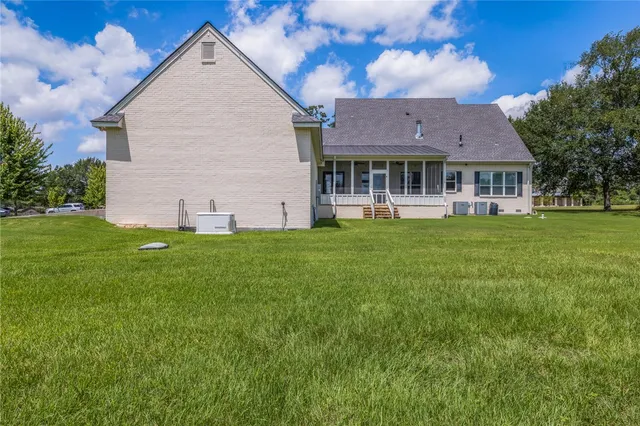 a front view of house with yard and green space