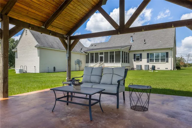 a view of a house with a big yard and potted plants