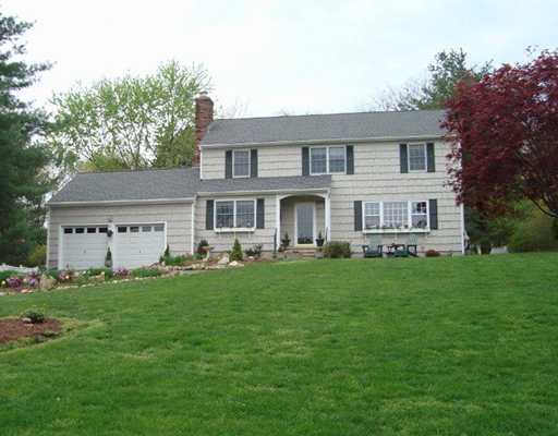 29 Chasmars Pond Road Darien, CT 06820 - Photo 1 of 16 a front view of a house with a yard and trees