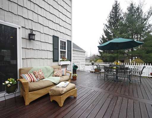 29 Chasmars Pond Road Darien, CT 06820 - Photo 13 of 16 a view of a patio with couches and table and chairs with wooden floor