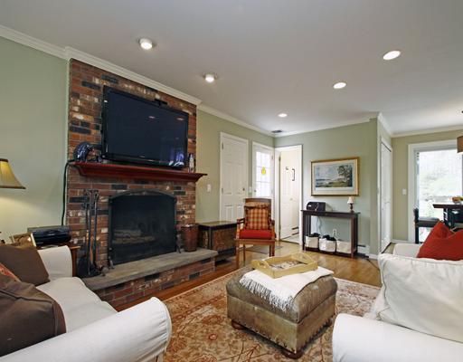 29 Chasmars Pond Road Darien, CT 06820 - Photo 7 of 16 a living room with furniture a flat screen tv and a fireplace