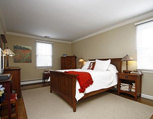 29 Chasmars Pond Road Darien, CT 06820 - Photo 8 of 16 a bed sitting in a bedroom next to a window
