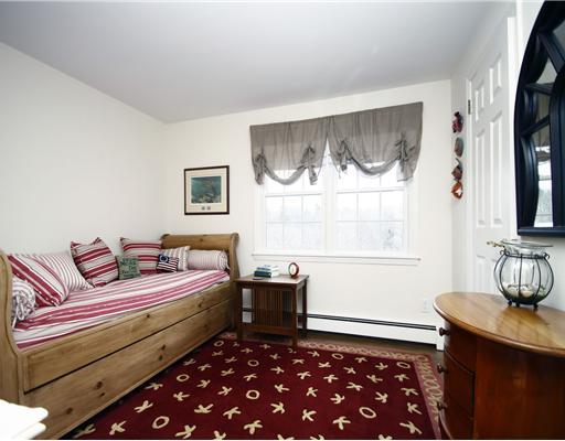 29 Chasmars Pond Road Darien, CT 06820 - Photo 10 of 16 a bedroom with a bed and a window
