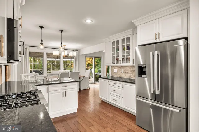 a kitchen with stainless steel appliances a refrigerator sink and microwave
