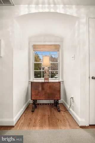 a bedroom with a large bed and a flat tv screen on dresser