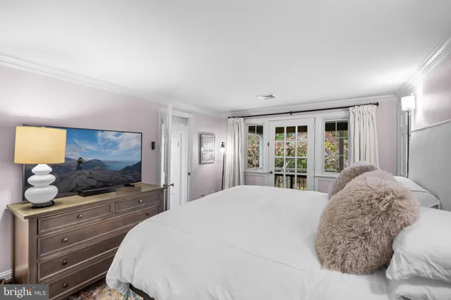 a bedroom with a bed and a television