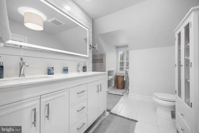 a bathroom with a sink a mirror and shower