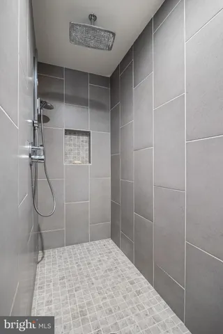 a bedroom with a large bed and a flat tv screen