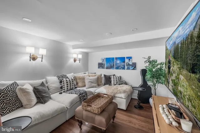a view of a house with a yard and a large tree