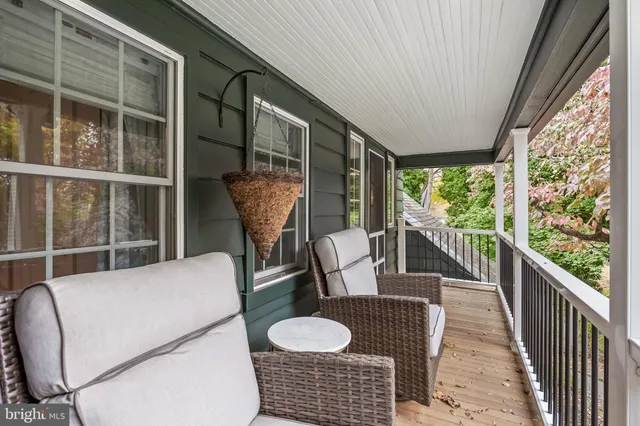 a balcony with table and chairs