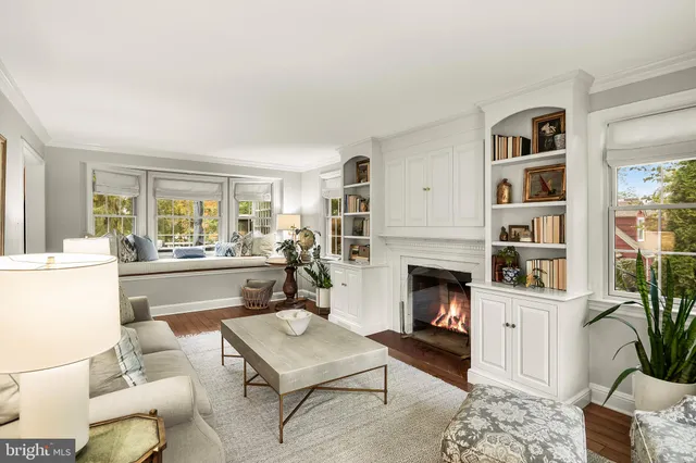 a living room with furniture fireplace and window