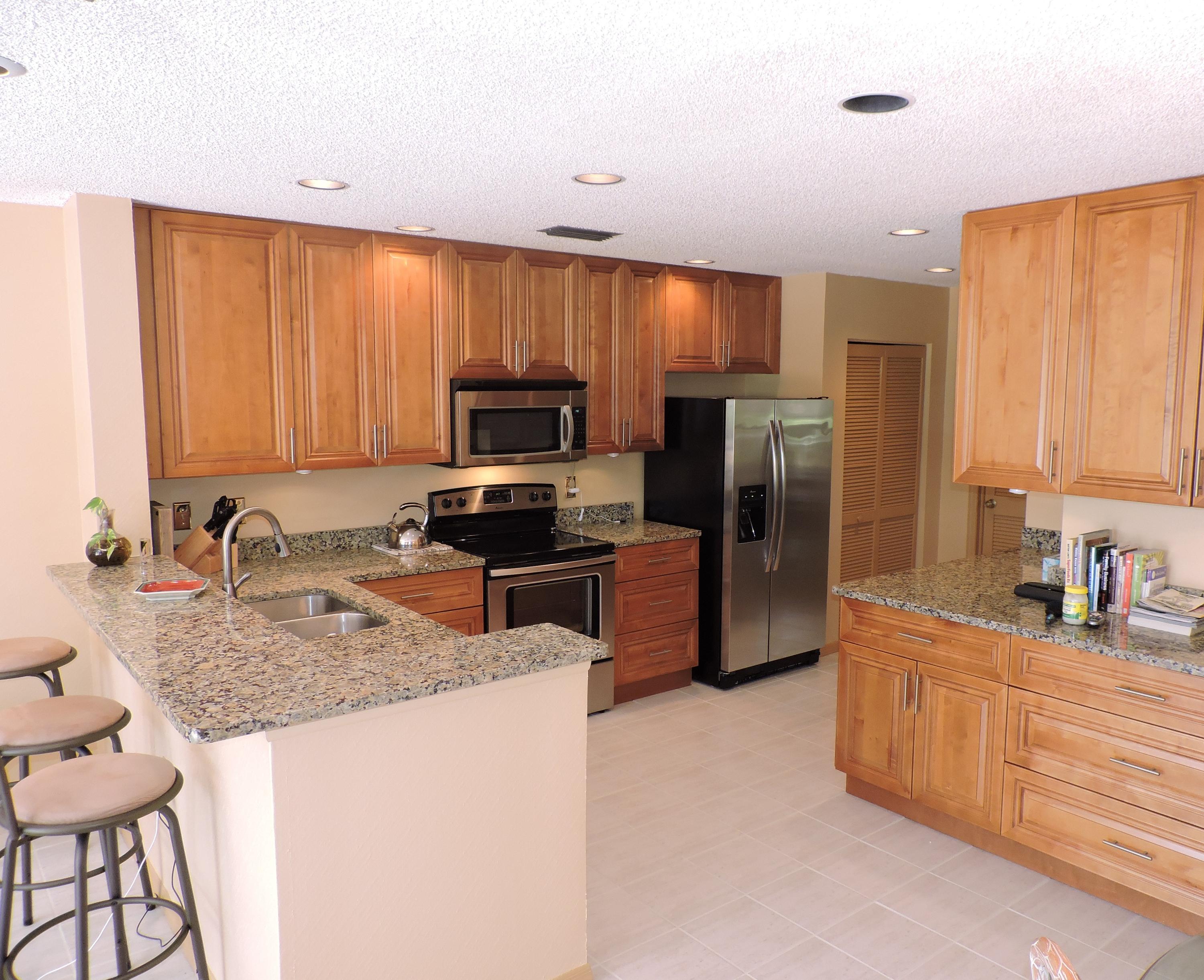 5254 Windsor Parke Drive Boca Raton, FL 33496 - Photo 11 of 25 a kitchen with stainless steel appliances granite countertop a refrigerator stove microwave and sink