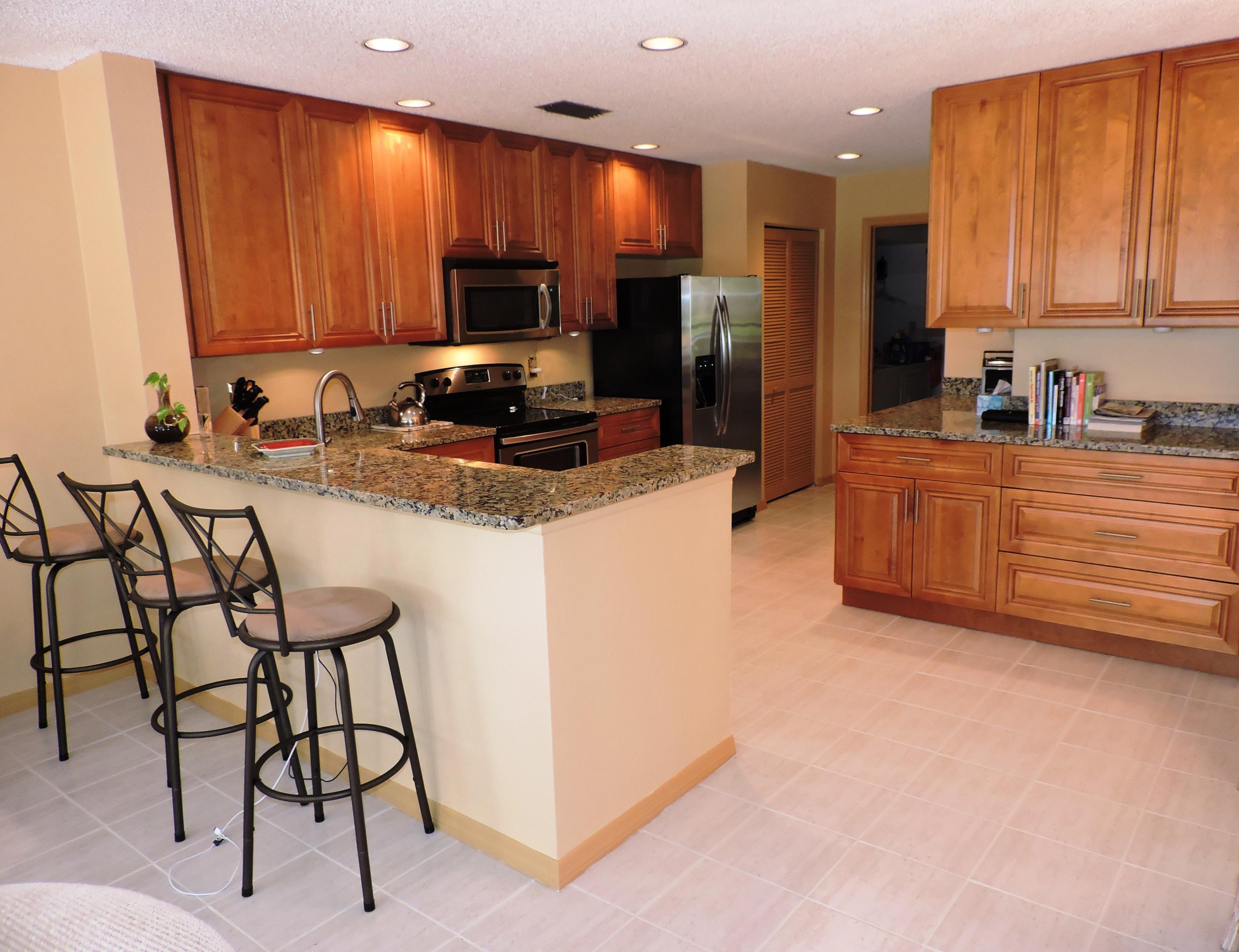 5254 Windsor Parke Drive Boca Raton, FL 33496 - Photo 12 of 25 a kitchen with granite countertop a refrigerator stove top oven and sink