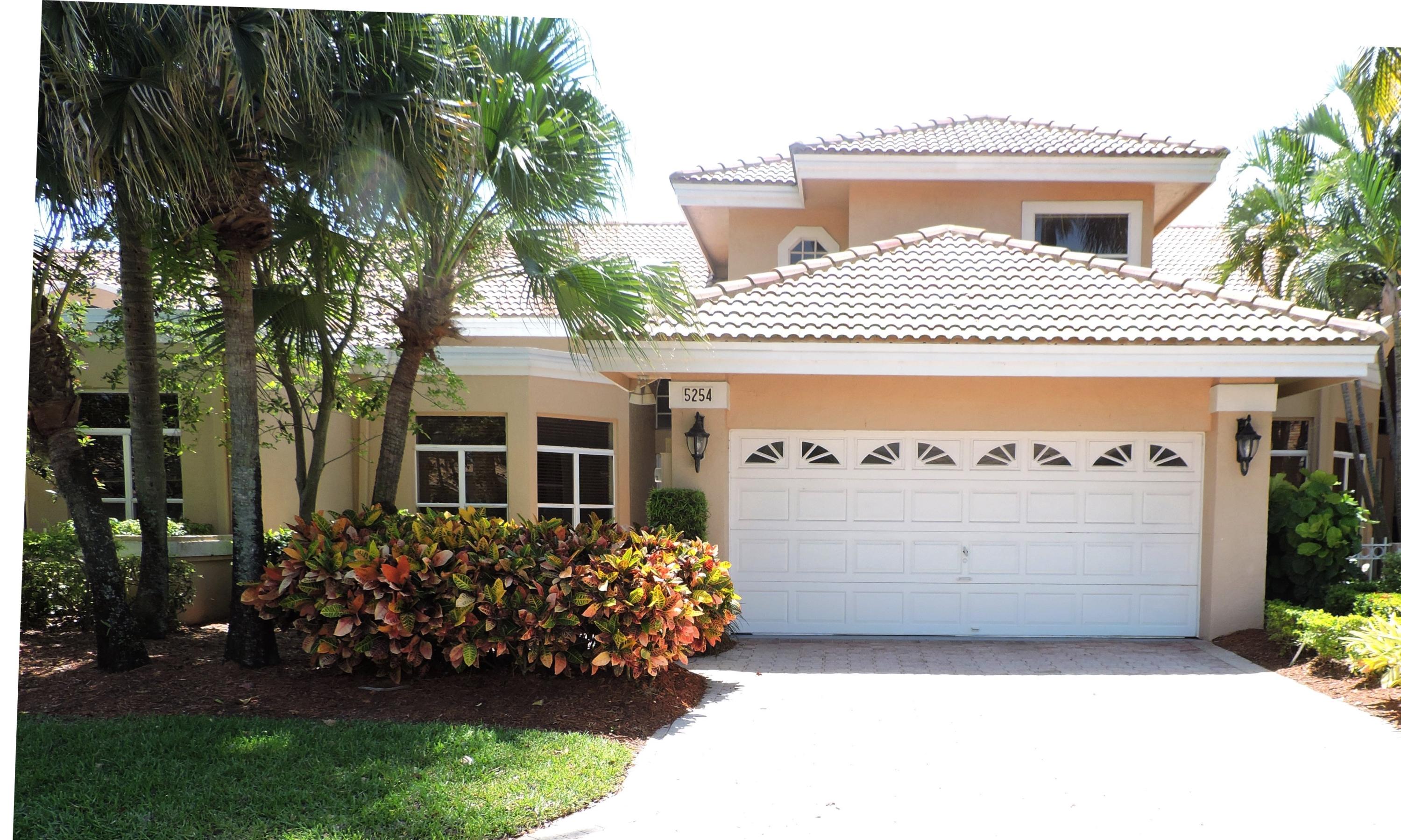 5254 Windsor Parke Drive Boca Raton, FL 33496 - Photo 2 of 25 a front view of a house with a garden