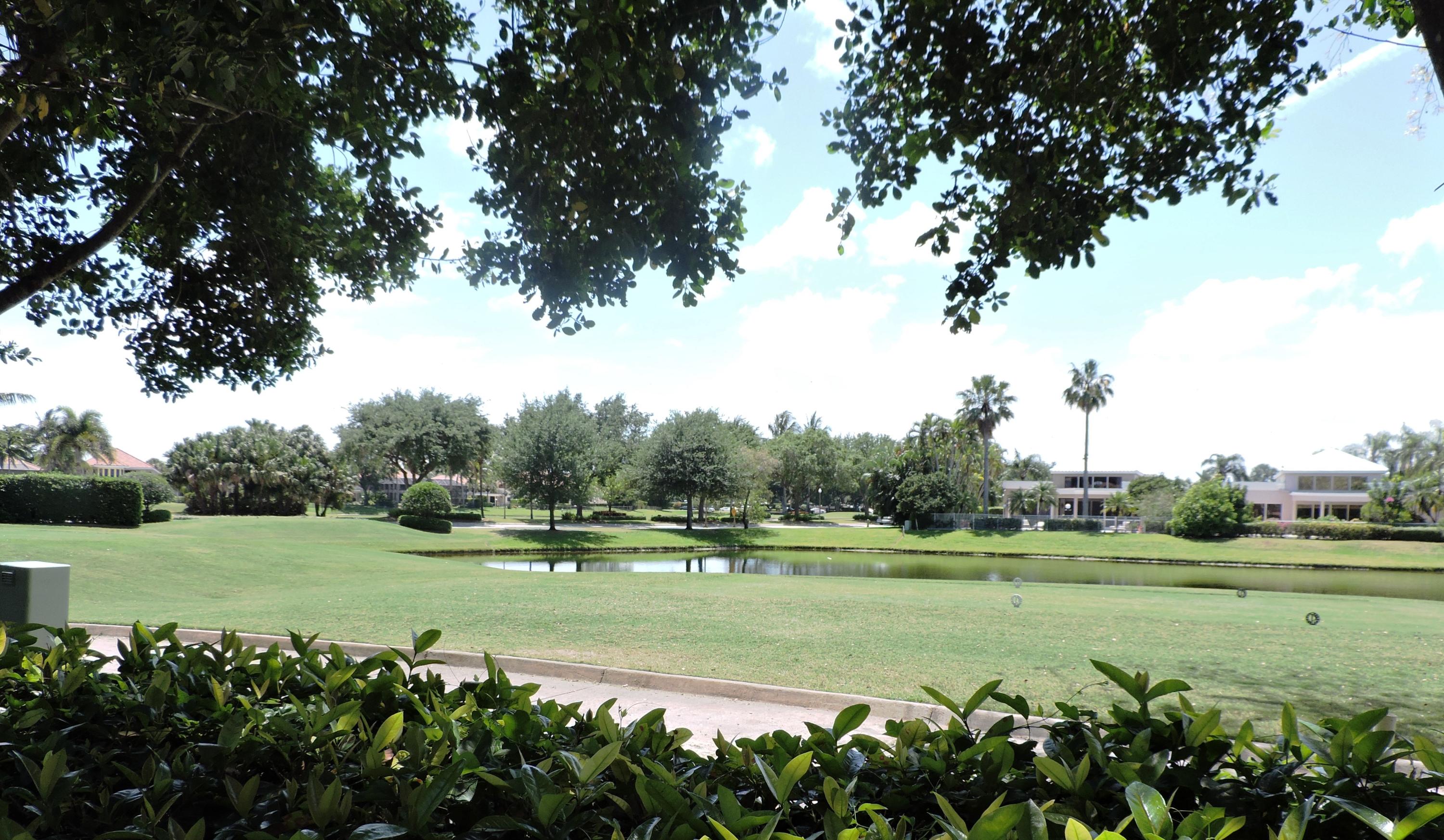 5254 Windsor Parke Drive Boca Raton, FL 33496 - Photo 3 of 25 a view of a golf course with a lake