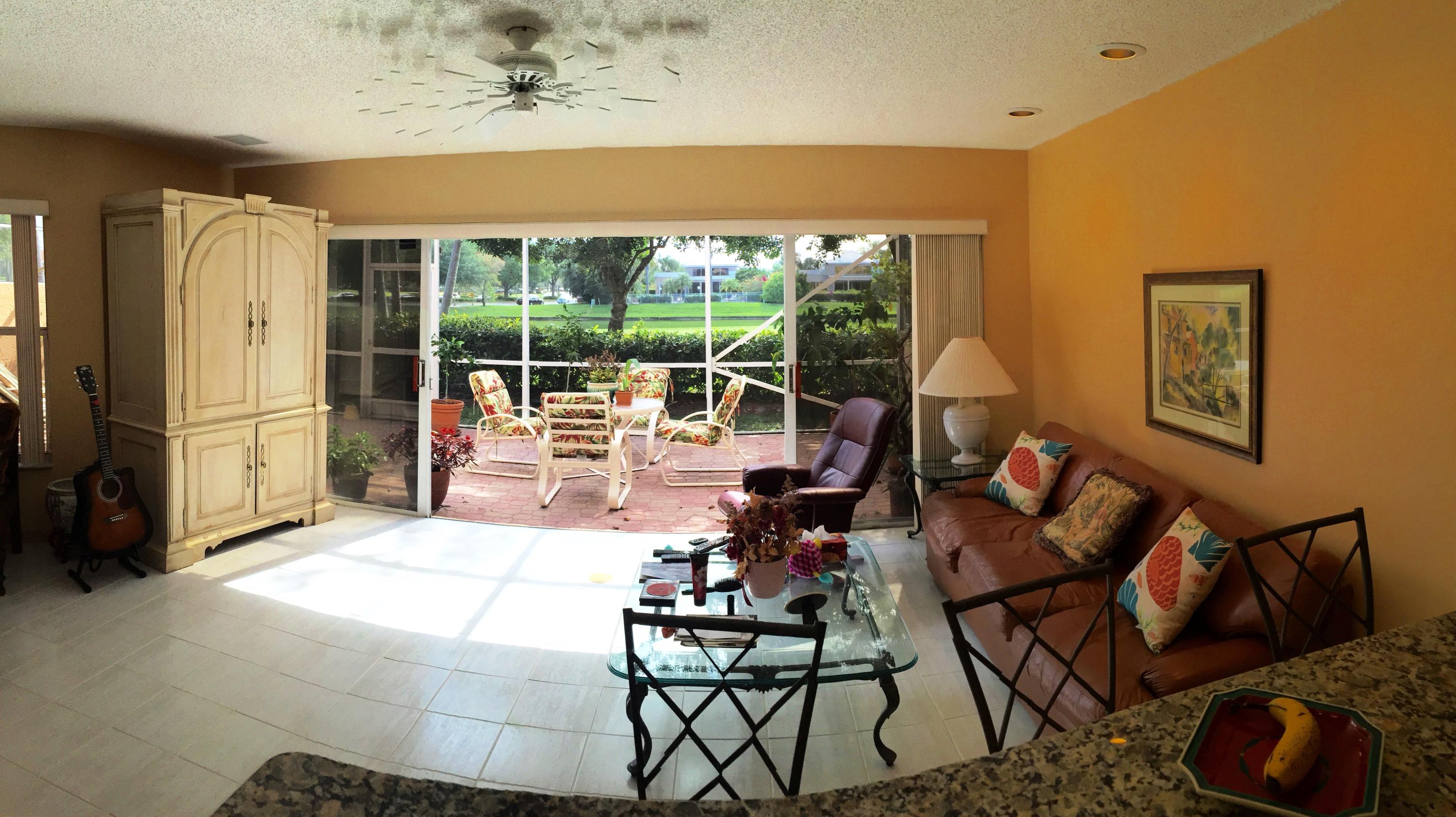 5254 Windsor Parke Drive Boca Raton, FL 33496 - Photo 5 of 25 a living room with fireplace furniture and a large window