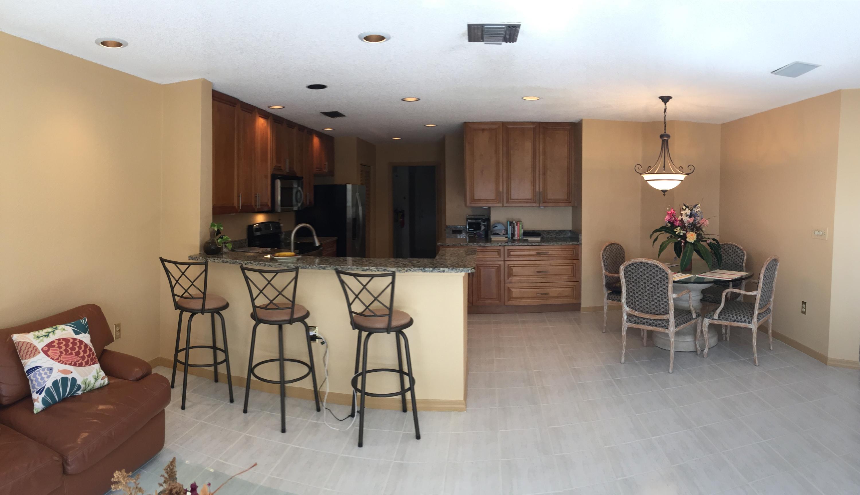 5254 Windsor Parke Drive Boca Raton, FL 33496 - Photo 10 of 25 a dinning room with kitchen island furniture and a chandelier