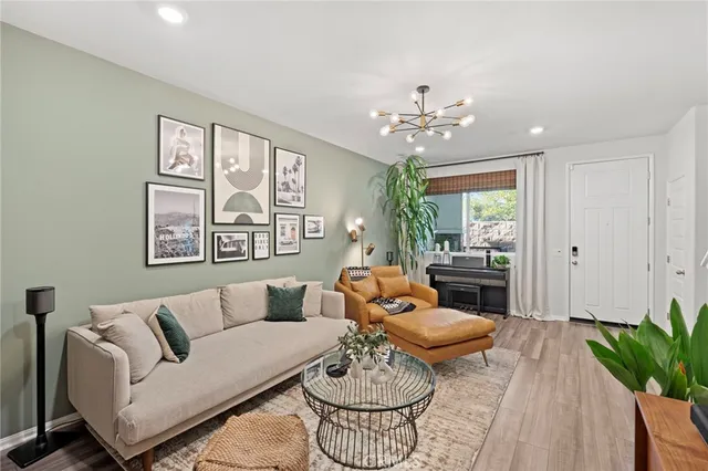 a living room with furniture potted plant and window