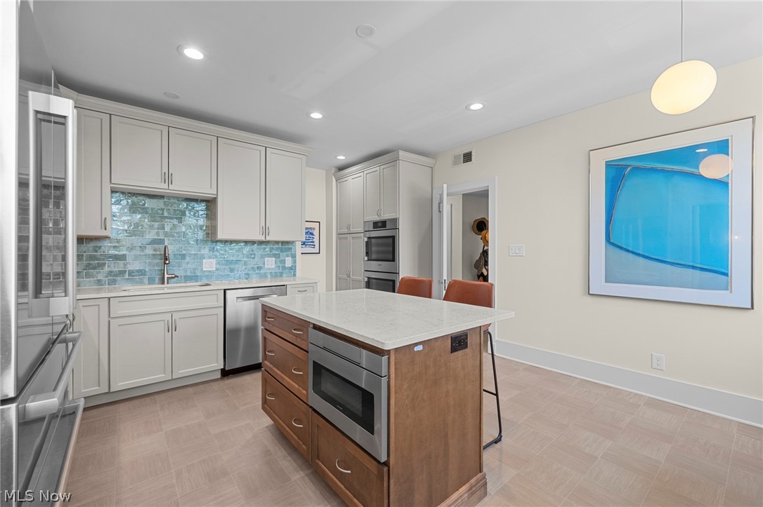 12546 Cedar Road, Unit 4 Cleveland Heights, OH 44106 - Photo 16 of 43 Newer windows, gourmet Kitchen taken down to the studs with center island and breakfast bar, 2 sinks, quartz counters, all Bosch stainless appliances with induction range and 2 ovens for large gatherings