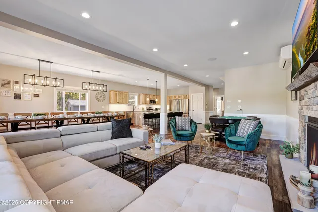 a living room with furniture a flat screen tv and a fireplace