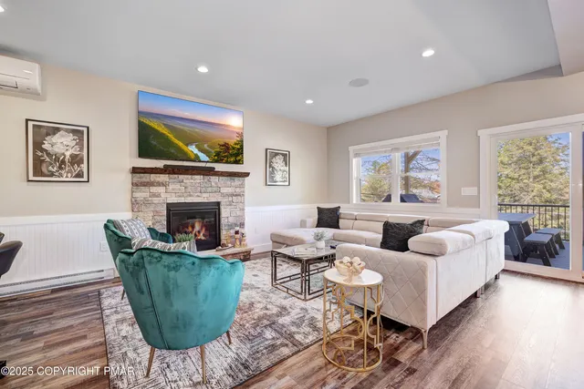 a view of a hallway with wooden floor and entryway