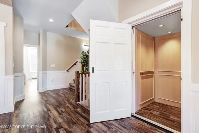 a view of living room with furniture and wooden floor