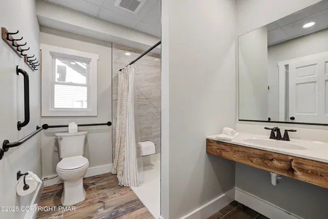 a bedroom with a bed wooden floor and window