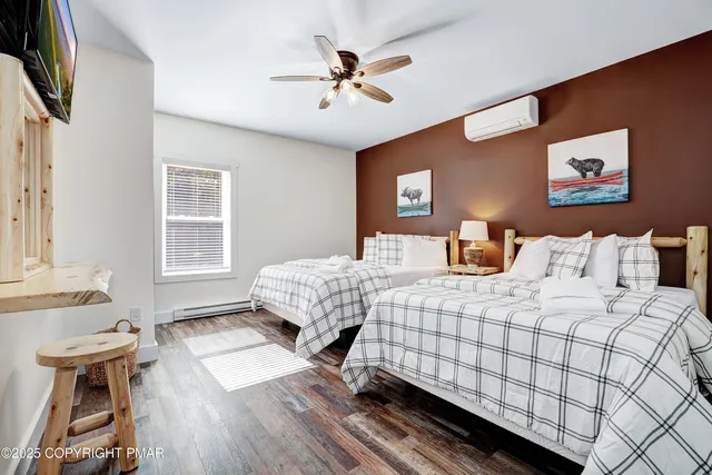 a bedroom with a bed and a view of living room