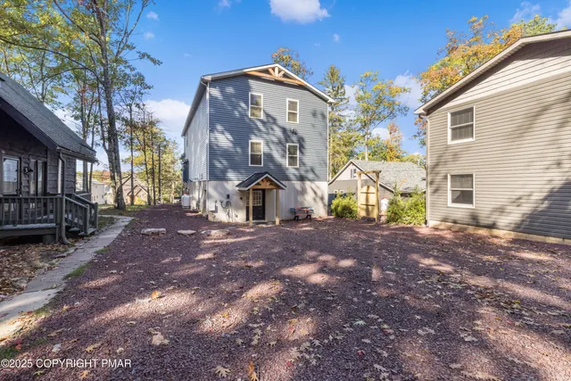 a kitchen with stainless steel appliances granite countertop a refrigerator a sink dishwasher a stove top oven a kitchen island and cabinets with wooden floor