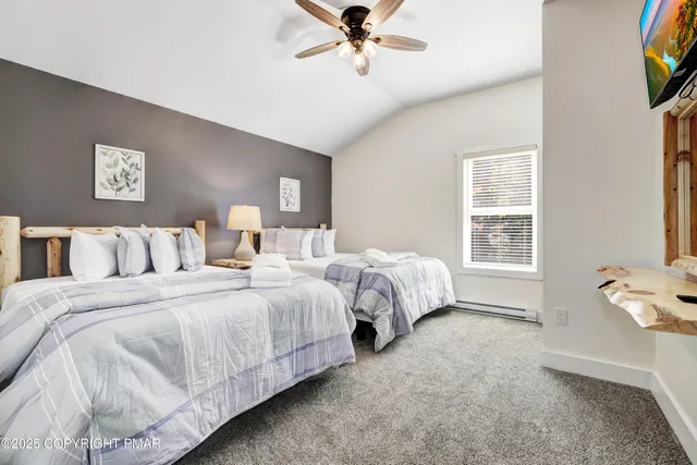 a living room with furniture a rug and a table