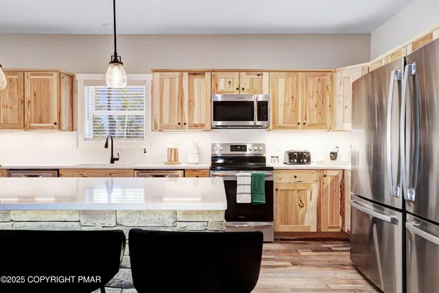 a kitchen with stainless steel appliances kitchen island a large island in the center