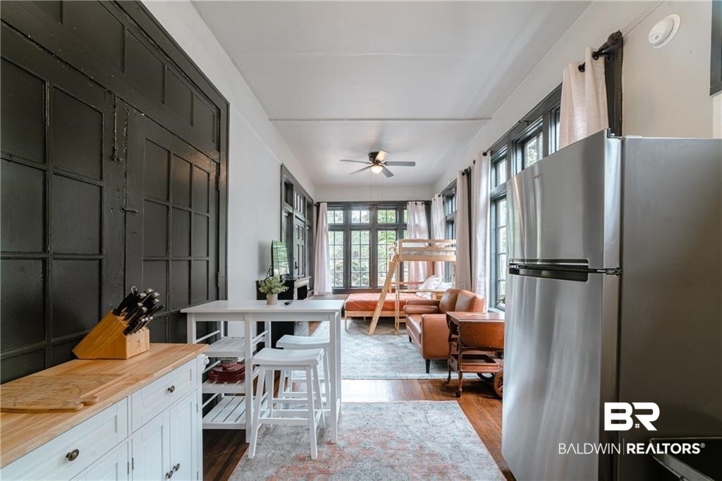 207 Michigan Avenue Mobile, AL 36604 - Photo 31 of 31 Kitchen with freestanding refrigerator, dark wood-type flooring, a ceiling fan, white cabinetry, and open floor plan