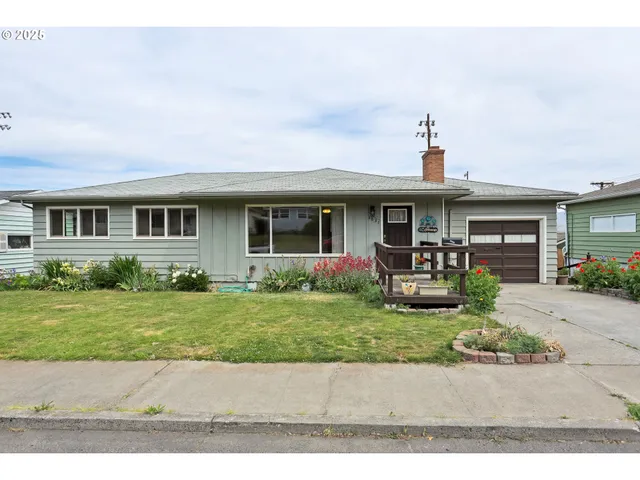 a front view of a house with garden and porch