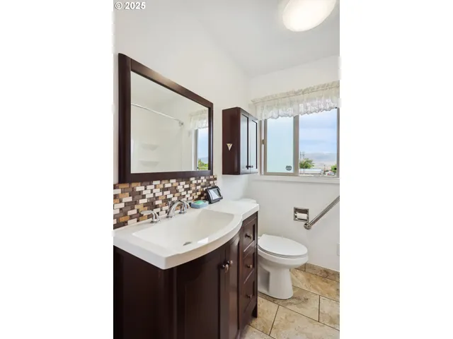 a bathroom with a sink toilet and mirror