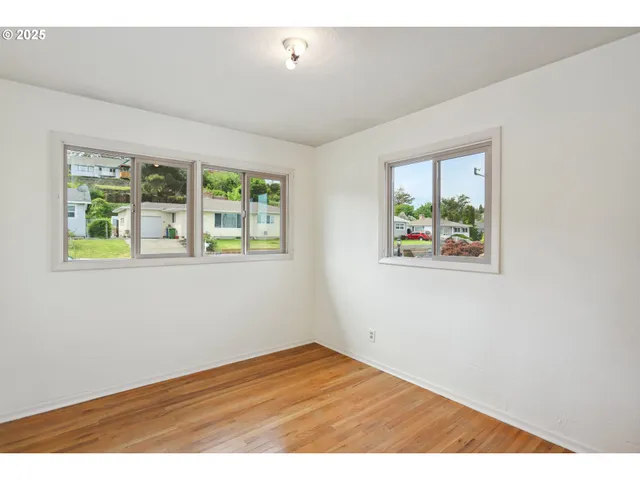 an empty room with windows and closet