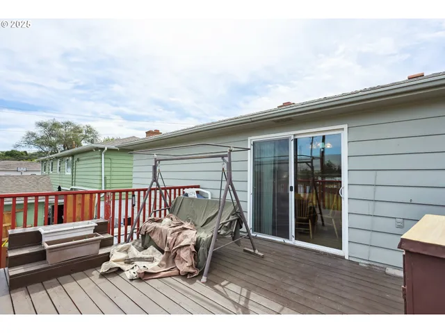 a roof deck with a table and chairs