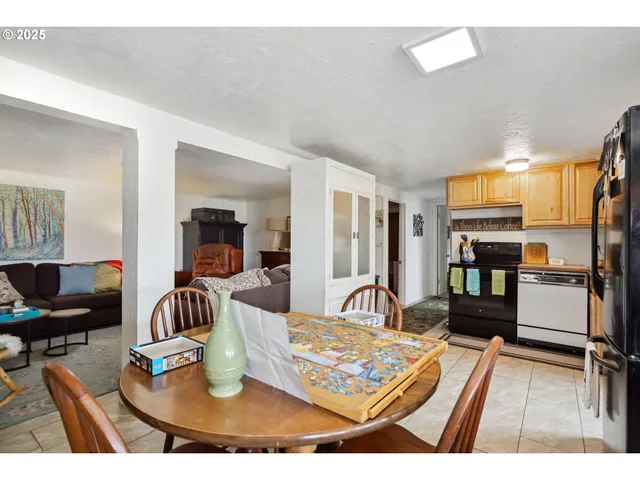 a living room with lots of furniture and kitchen view