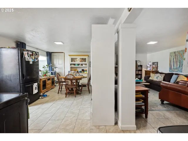 a living room with furniture a window and a flat screen tv
